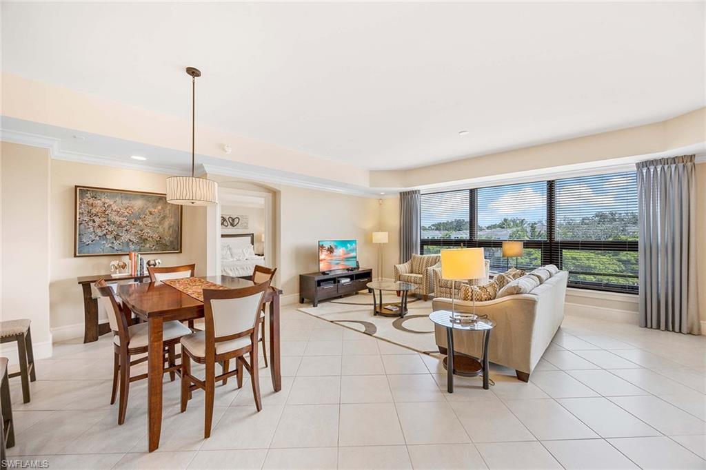 9115 Strada Place, Unit 5213 Naples, FL 34108 - Photo 5 of 32 a living room with furniture and a large window