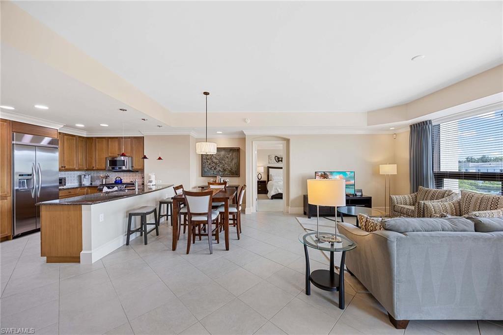 9115 Strada Place, Unit 5213 Naples, FL 34108 - Photo 6 of 32 a living room with lots of furniture and a large window
