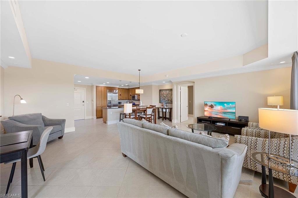 9115 Strada Place, Unit 5213 Naples, FL 34108 - Photo 7 of 32 a living room with furniture and a flat screen tv