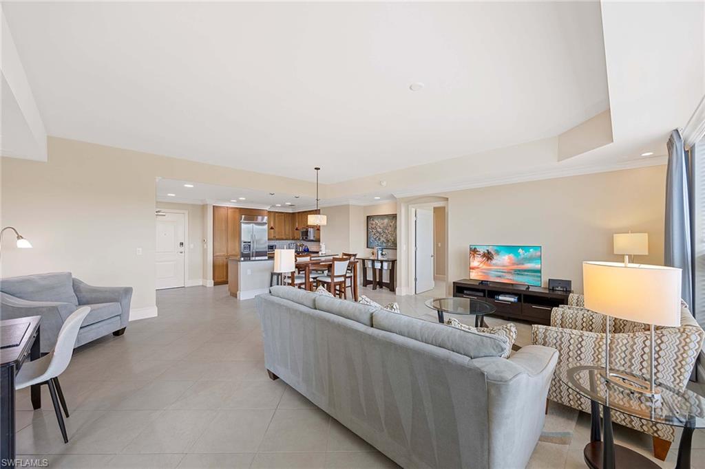 9115 Strada Place, Unit 5213 Naples, FL 34108 - Photo 10 of 32 a living room with furniture and a wooden floor