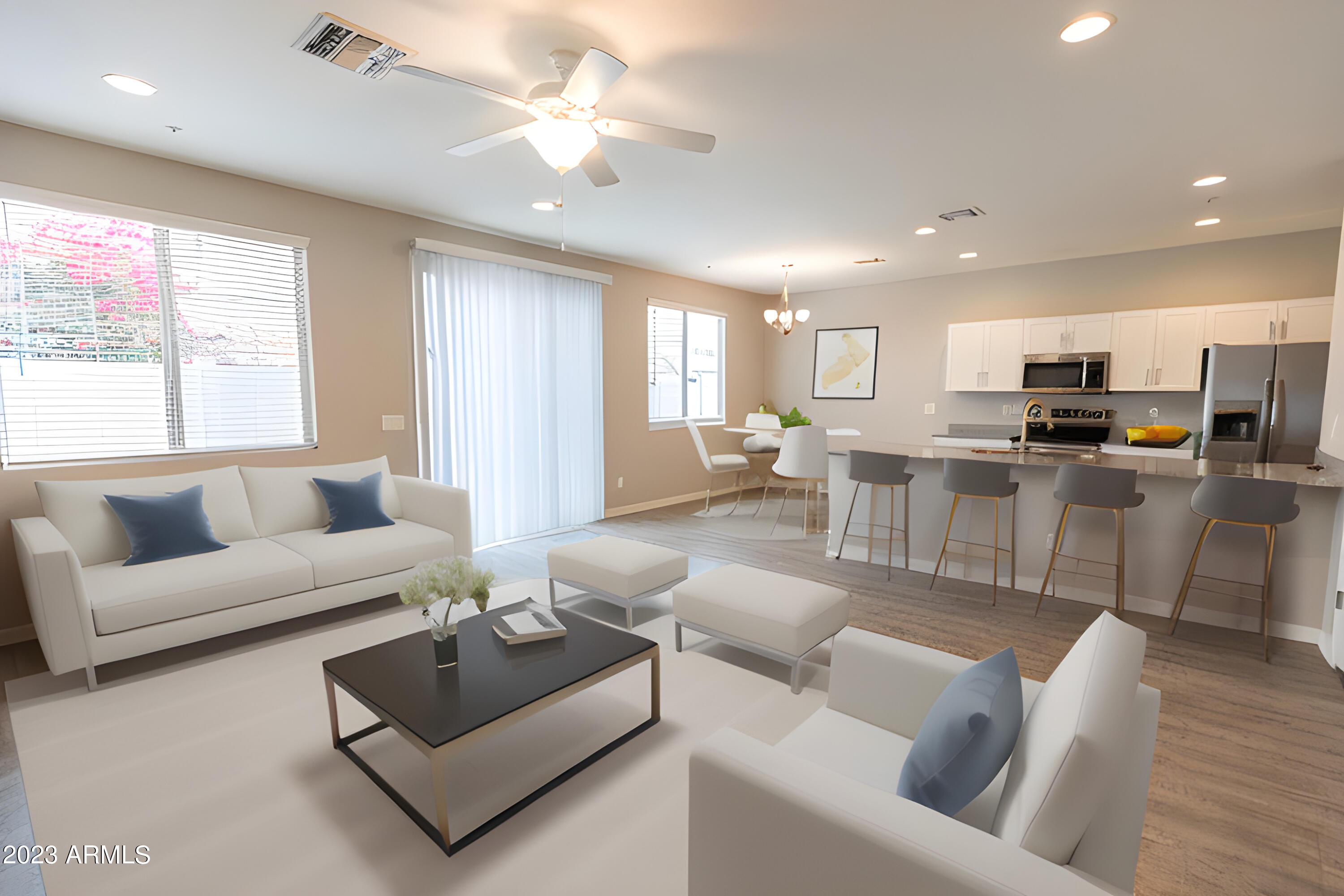 a living room with furniture kitchen view and a large window