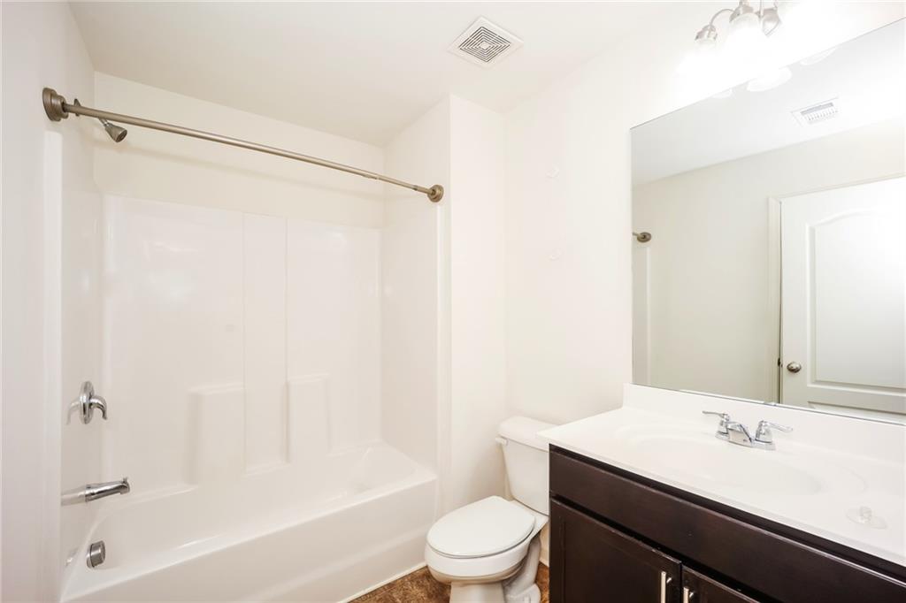 7638 Bucknell Terrace Fairburn, GA 30213 - Photo 13 of 17 a bathroom with a granite countertop sink toilet and shower