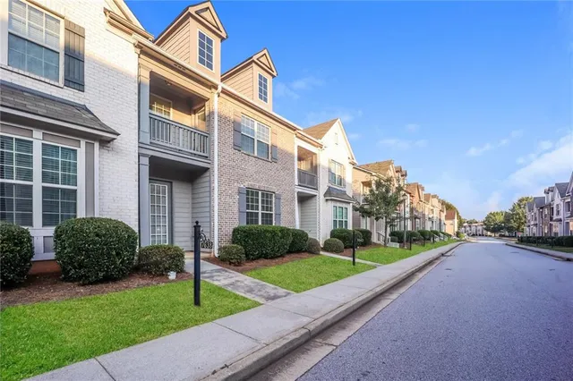 a view of a house with a backyard and a table and chairs