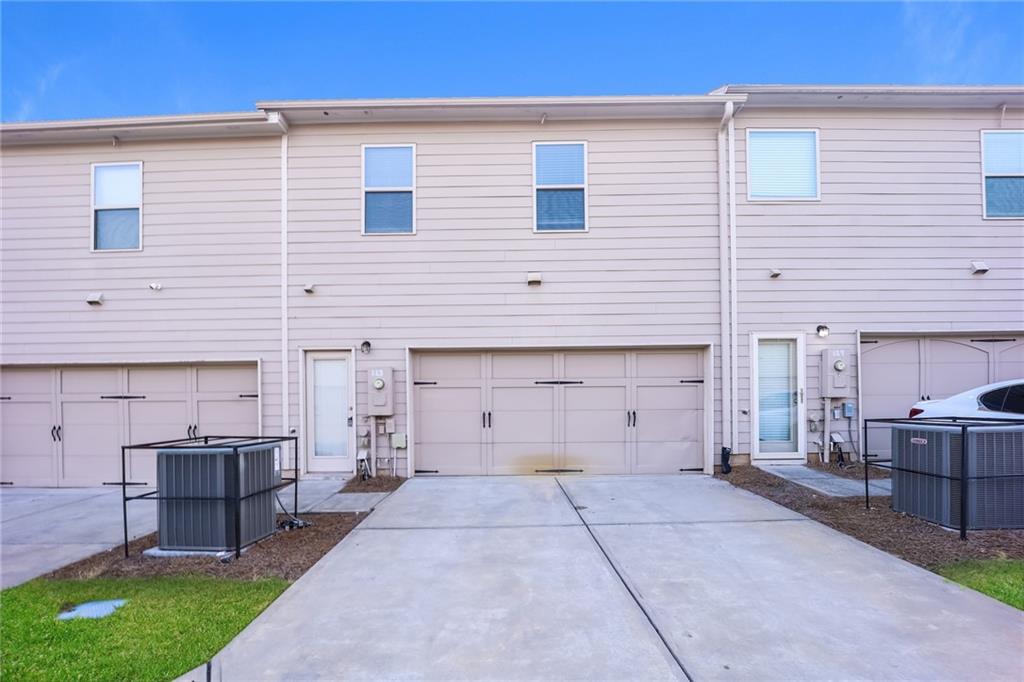 7638 Bucknell Terrace Fairburn, GA 30213 - Photo 15 of 17 a view of a house with a backyard and a table and chairs