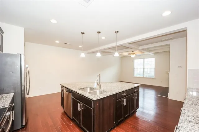 a kitchen with a sink and a refrigerator