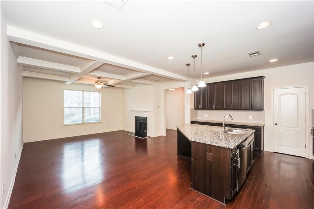 7638 Bucknell Terrace Fairburn, GA 30213 - Photo 5 of 17 a kitchen with granite countertop a stove a sink and a refrigerator