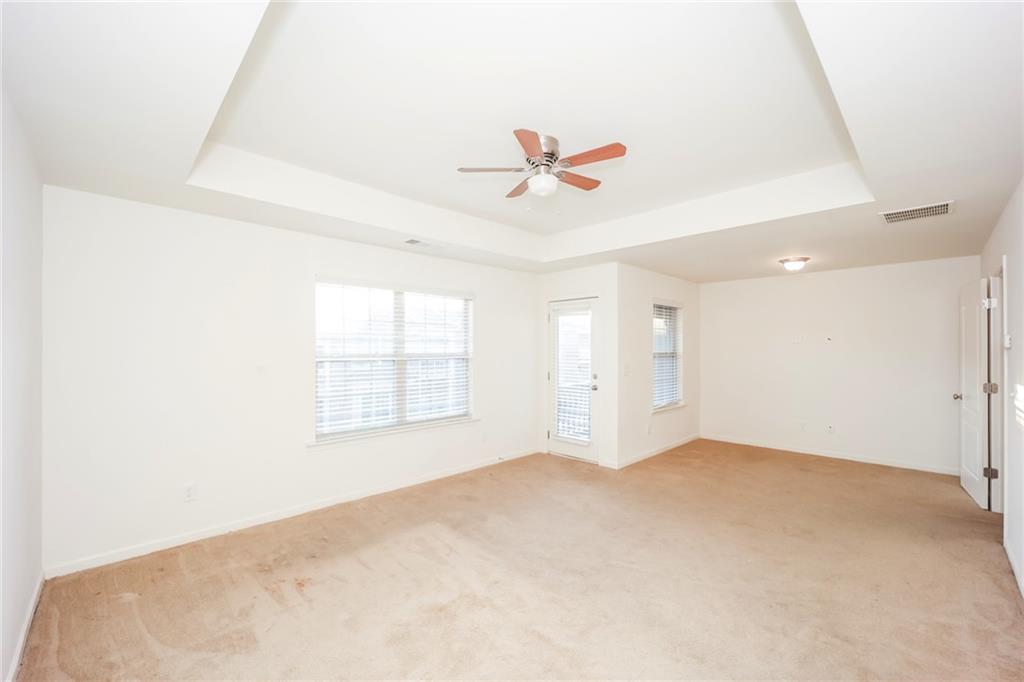 7638 Bucknell Terrace Fairburn, GA 30213 - Photo 8 of 17 an empty room with windows and fan