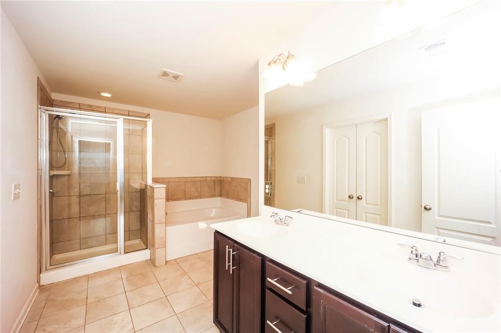 7638 Bucknell Terrace Fairburn, GA 30213 - Photo 10 of 17 a spacious bathroom with a shower sink and mirror