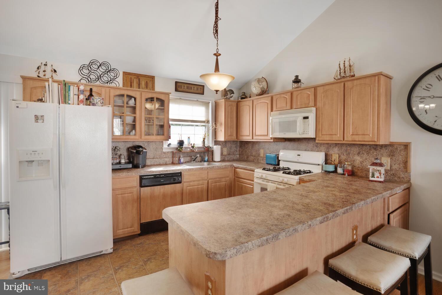 1321 Radio Road Little Egg Harbor, NJ 08087 - Photo 14 of 32 a kitchen with granite countertop a refrigerator a stove a sink dishwasher and white cabinets with wooden floor