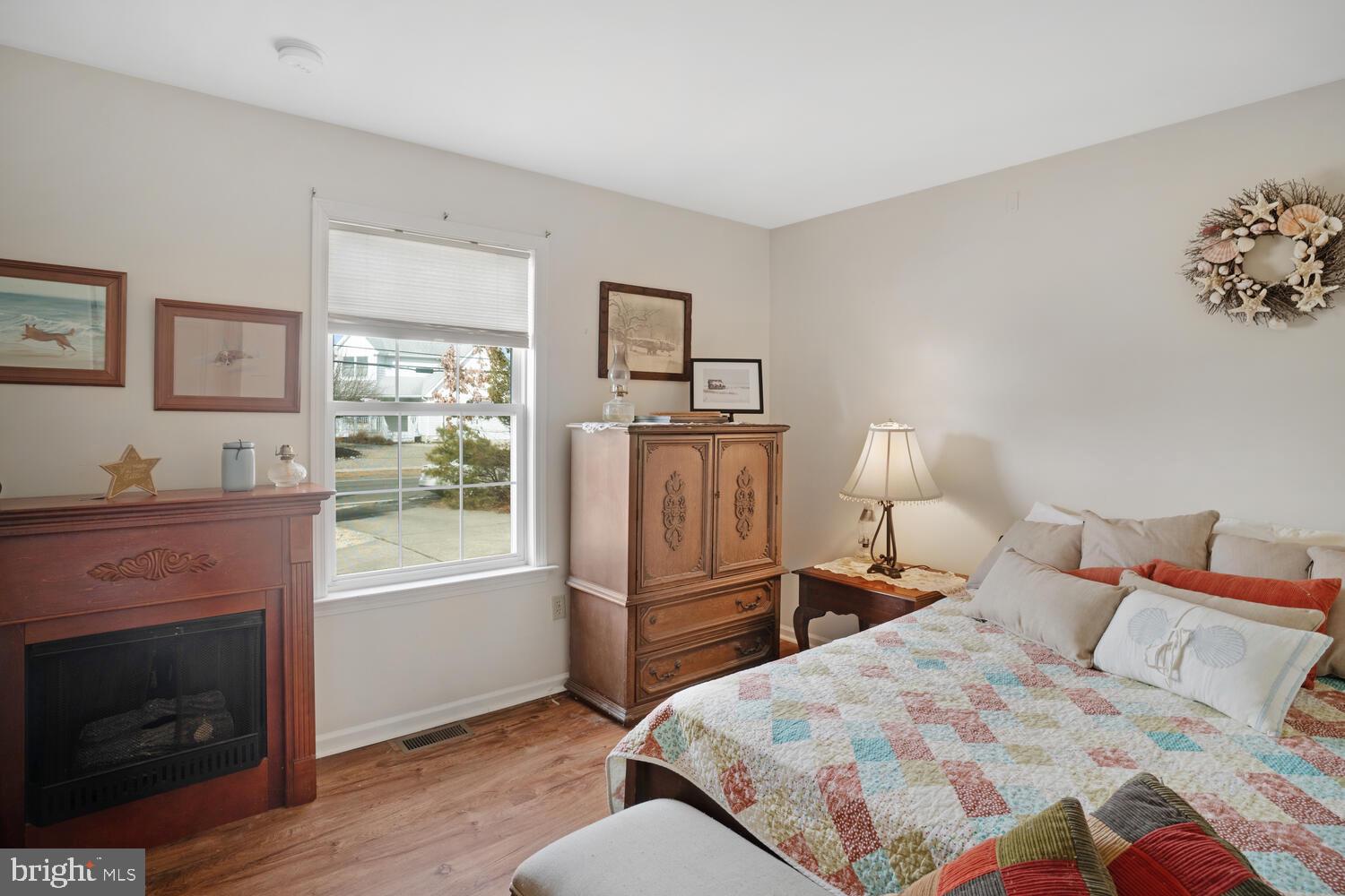 1321 Radio Road Little Egg Harbor, NJ 08087 - Photo 28 of 32 a bed room with a bed and a fireplace