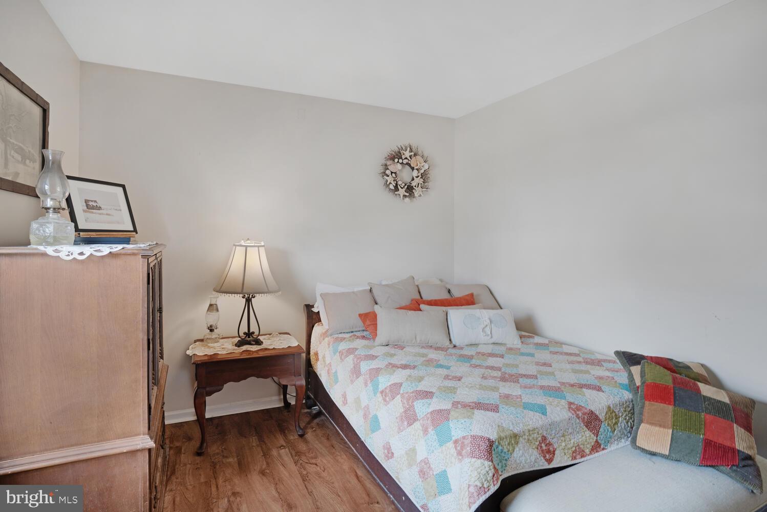1321 Radio Road Little Egg Harbor, NJ 08087 - Photo 29 of 32 a bedroom with a bed and a lamp on table
