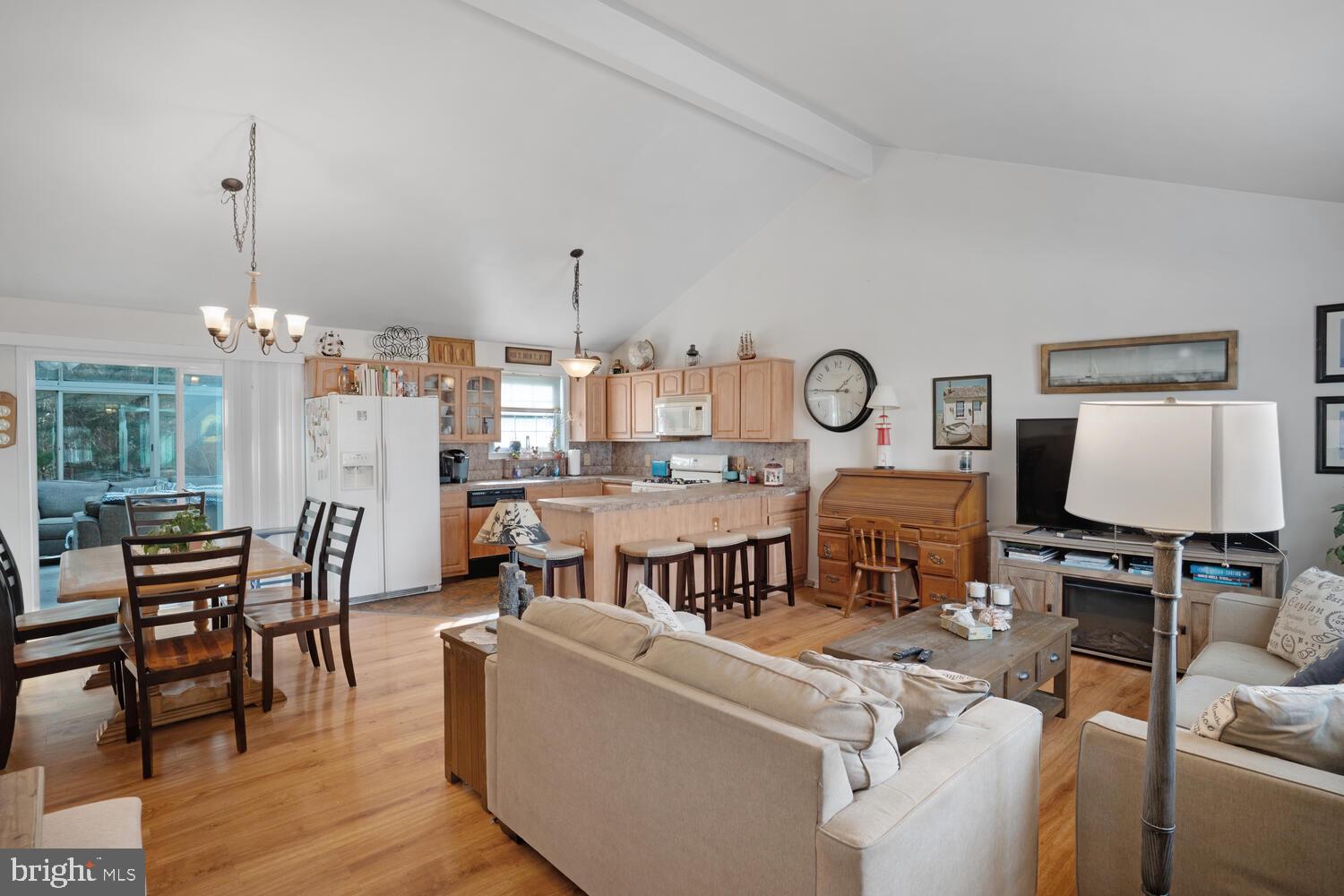 1321 Radio Road Little Egg Harbor, NJ 08087 - Photo 10 of 32 a living room with furniture a dining table and a chandelier