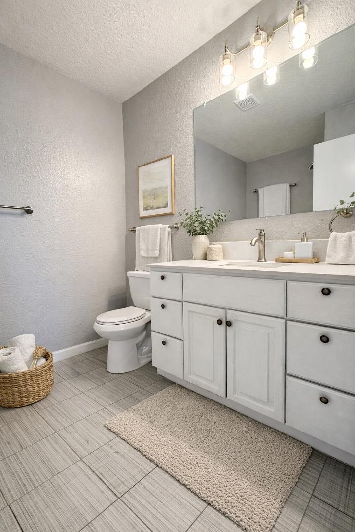 8 Lancaster Circle, Unit 224 Bay Point, CA 94565 - Photo 25 of 33 a spacious bathroom with a toilet sink and mirror