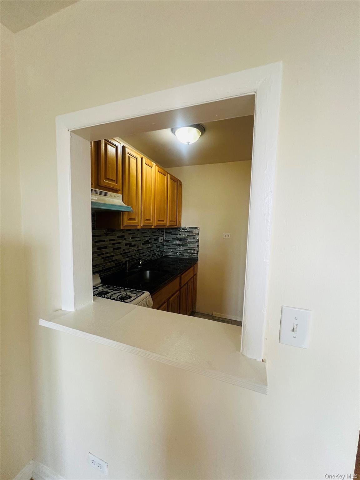 2181 Starling Avenue, Unit 5D Bronx, NY 10462 - Photo 3 of 5 a view of a hallway to a room with wooden floor