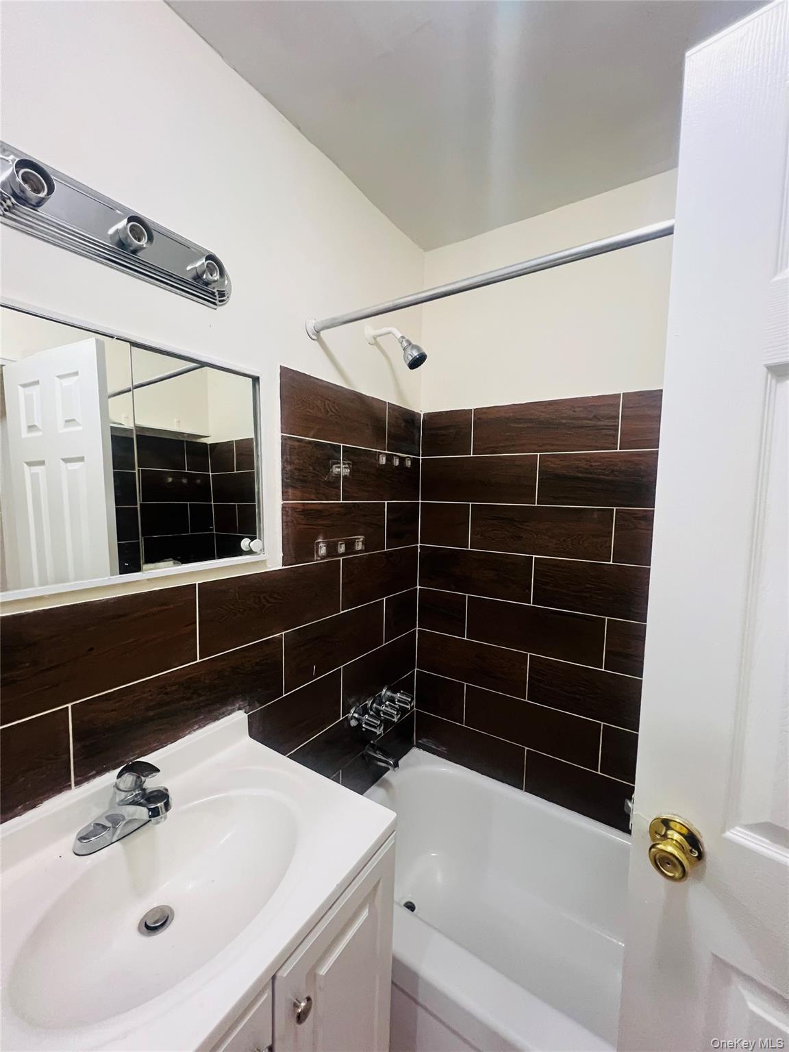 2181 Starling Avenue, Unit 5D Bronx, NY 10462 - Photo 5 of 5 a bathroom with a sink and a bathtub