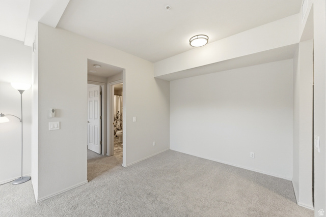 900 Bitner Road, Unit P20 Park City, UT 84098 - Photo 16 of 42 Carpeted interior space featuring a flush-mount ceiling light fixture, neutral wall finishes, and a doorway leading to an additional interior room
