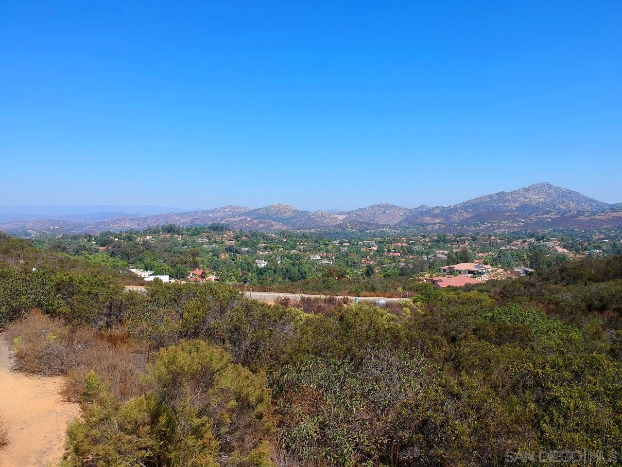 7 Del Poniente Road Poway, CA 92064 - Photo 13 of 26 a view of a lush green field with lots of trees in the background