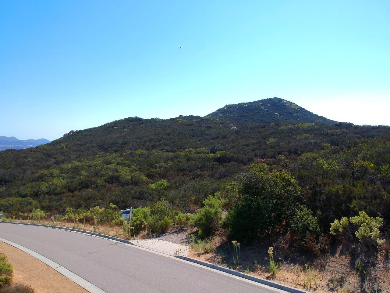 7 Del Poniente Road Poway, CA 92064 - Photo 20 of 26 a view of a street with a mountain in the background