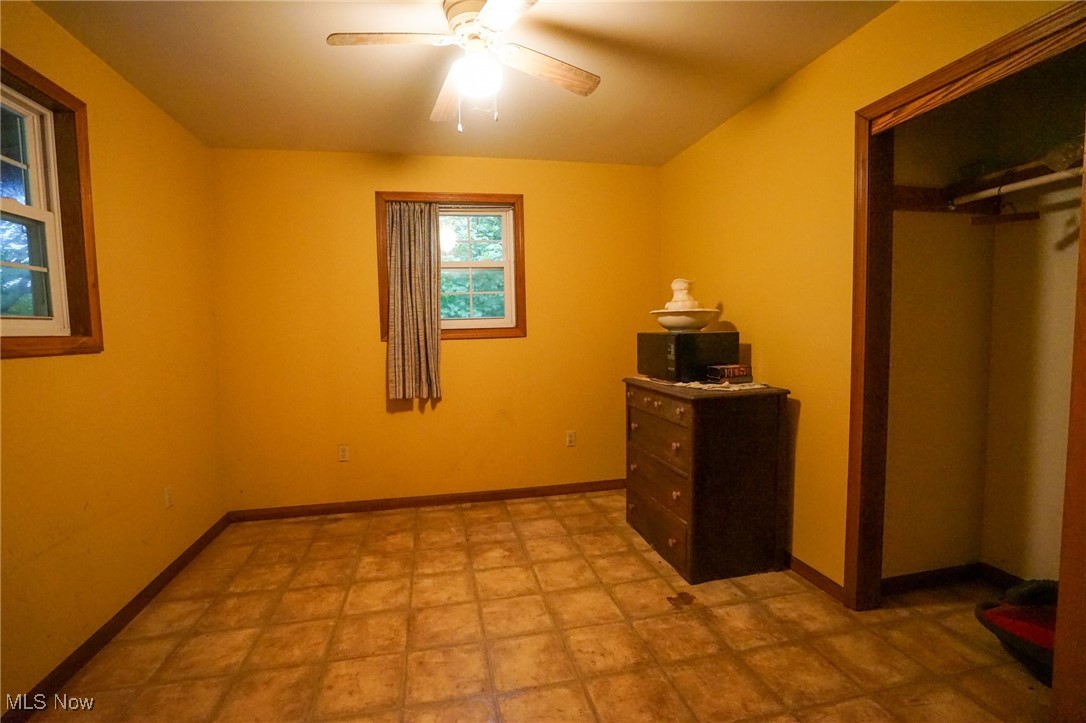 34799 Paw Road Lower Salem, OH 45745 - Photo 16 of 50 Unfurnished bedroom with ceiling fan and a closet