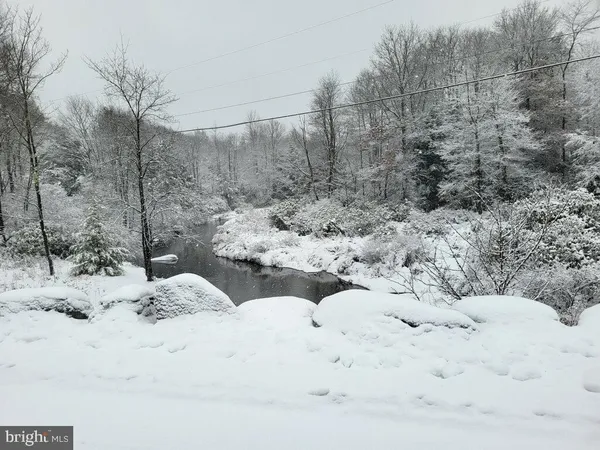 a view of a dry yard covered in snow