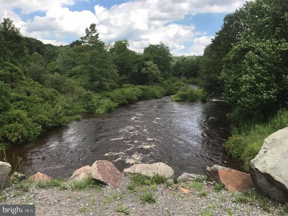 Lot 36 Fox Tail Road Oakland, MD 21550 - Photo 5 of 16 a backyard of a house with a yard and lake