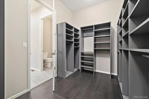 a view of walk in closet with empty racks