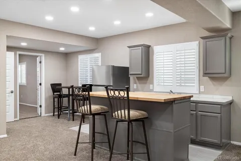 a kitchen that has a table and chairs in it