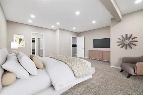 a spacious bedroom with a bed and a couch