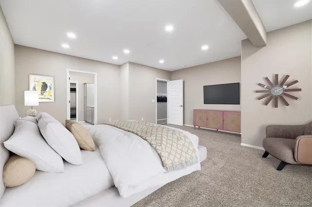 a spacious bedroom with a bed and a couch