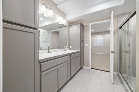 a bathroom with a double vanity sink and mirror