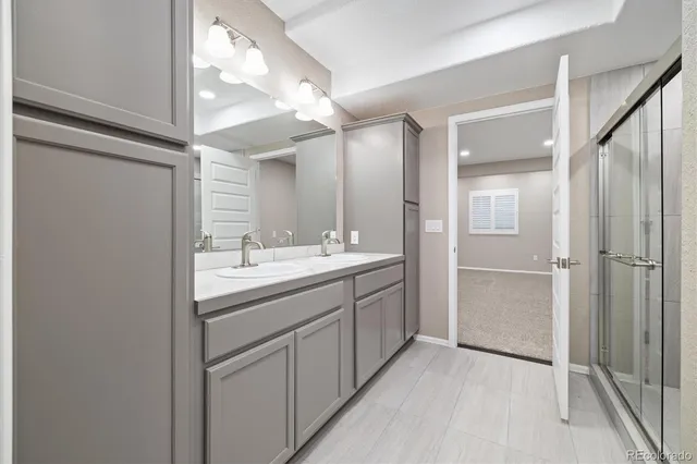 a bathroom with a double vanity sink and mirror