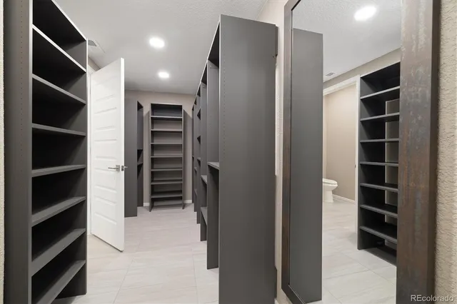 a view of walk in closet with empty racks