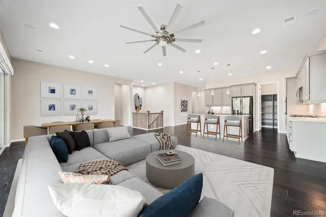 a living room with furniture and a view of kitchen