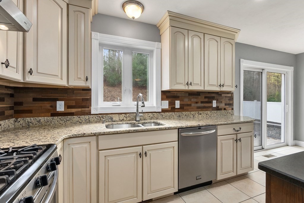 38 Draper Woods Road Sturbridge, MA 01518 - Photo 12 of 42 a kitchen with granite countertop white cabinets and a stove