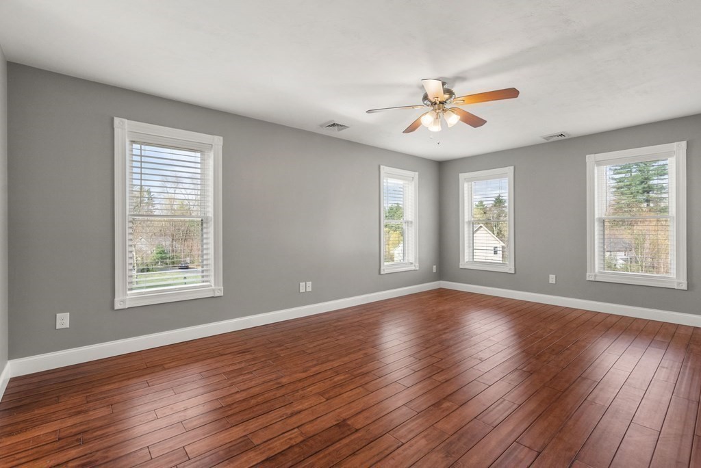 38 Draper Woods Road Sturbridge, MA 01518 - Photo 23 of 42 a view of an empty room with wooden floor and a window