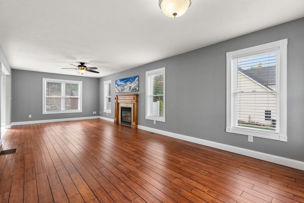 38 Draper Woods Road Sturbridge, MA 01518 - Photo 6 of 42 an empty room with wooden floor and windows