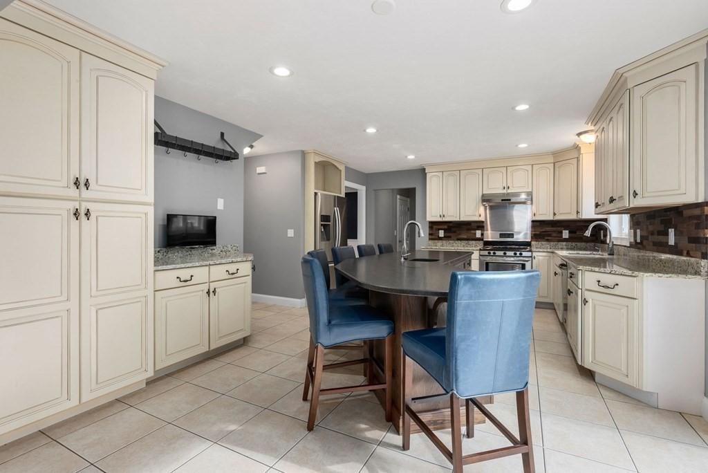 38 Draper Woods Road Sturbridge, MA 01518 - Photo 9 of 42 a kitchen with white cabinets and stainless steel appliances