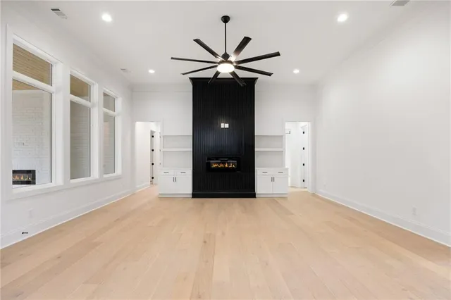 a view of a livingroom with a ceiling fan and window