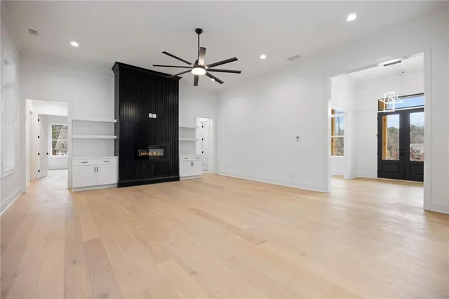 a view of empty room with a window and a ceiling fan