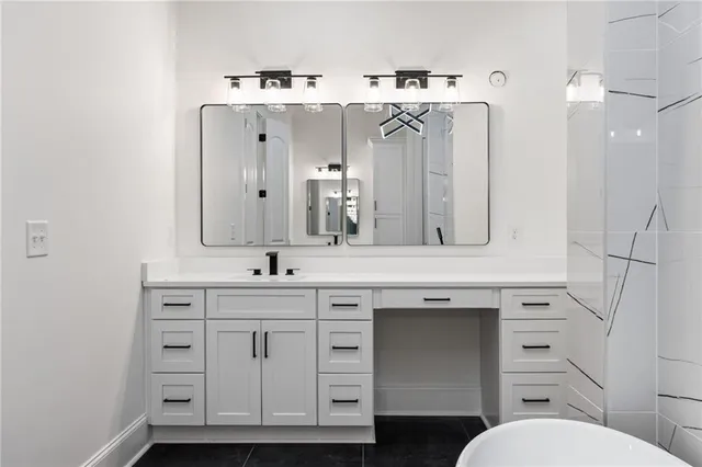 a bathroom with a sink vanity and mirror