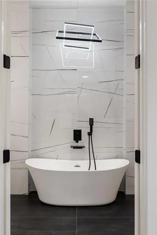 a white tub sitting in a bathroom