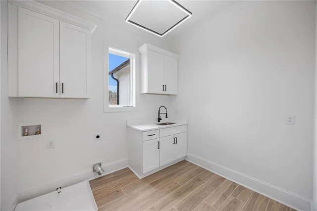 a room with a sink cabinets and wooden floor