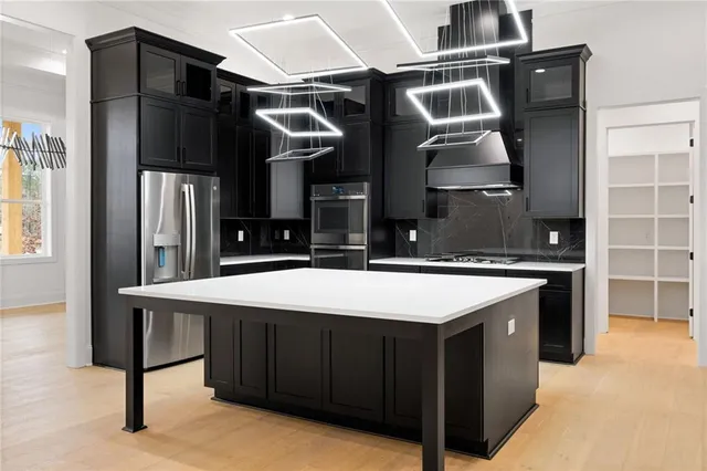 a kitchen with a sink cabinets and stainless steel appliances