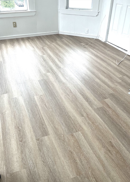 92 Emory Street, Unit 1 Attleboro, MA 02703 - Photo 4 of 8 a view of empty room with window and wooden floor