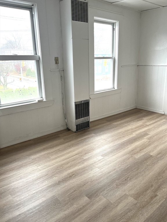 92 Emory Street, Unit 1 Attleboro, MA 02703 - Photo 7 of 8 an empty room with wooden floor and windows