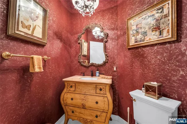a bathroom with a toilet sink and mirror