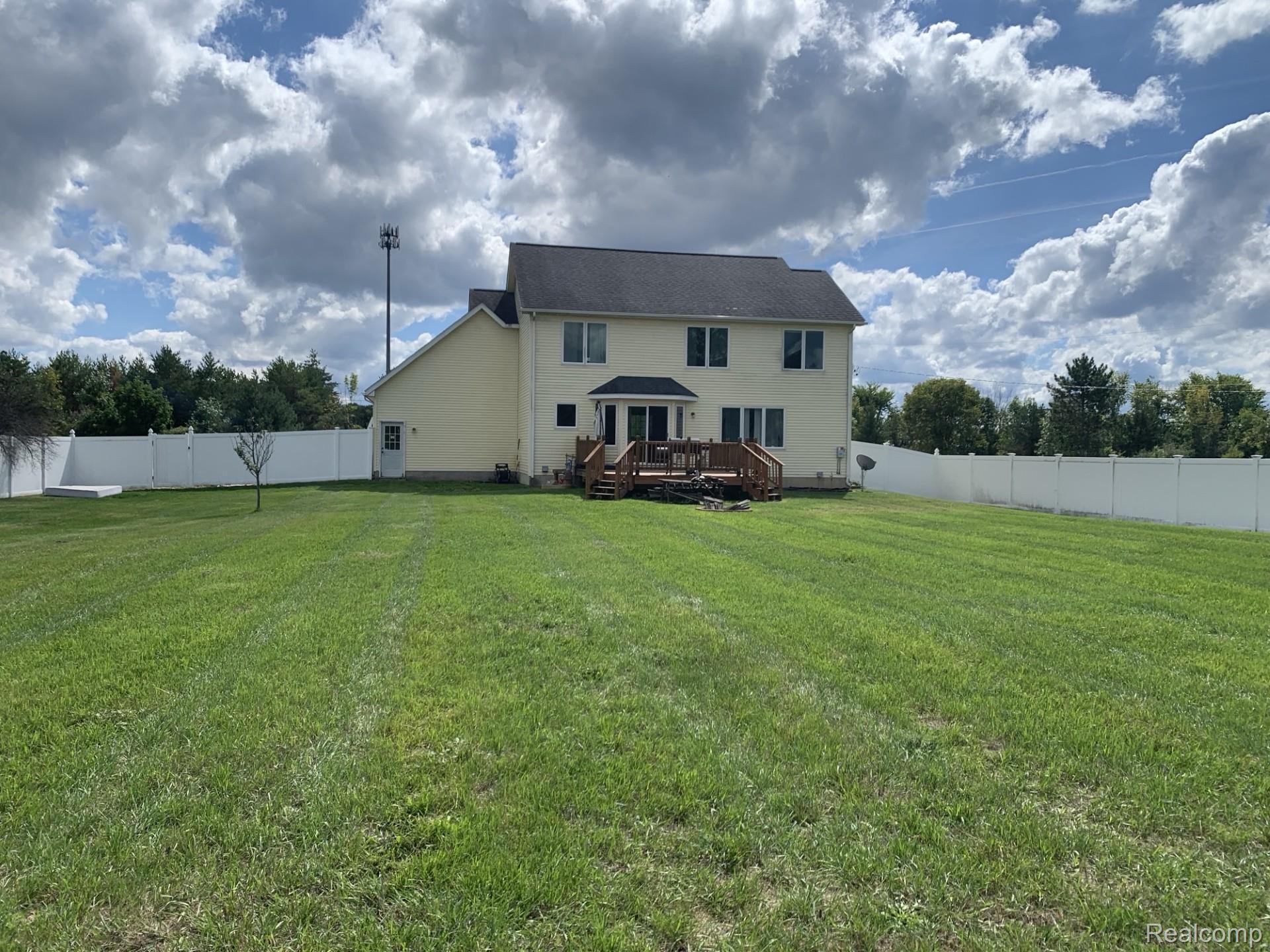 3068 West Cook Road Grand Blanc, MI 48439 - Photo 3 of 31 Expansive lawn bordered by a white privacy fence