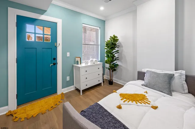 a bedroom with a bed and wooden floor