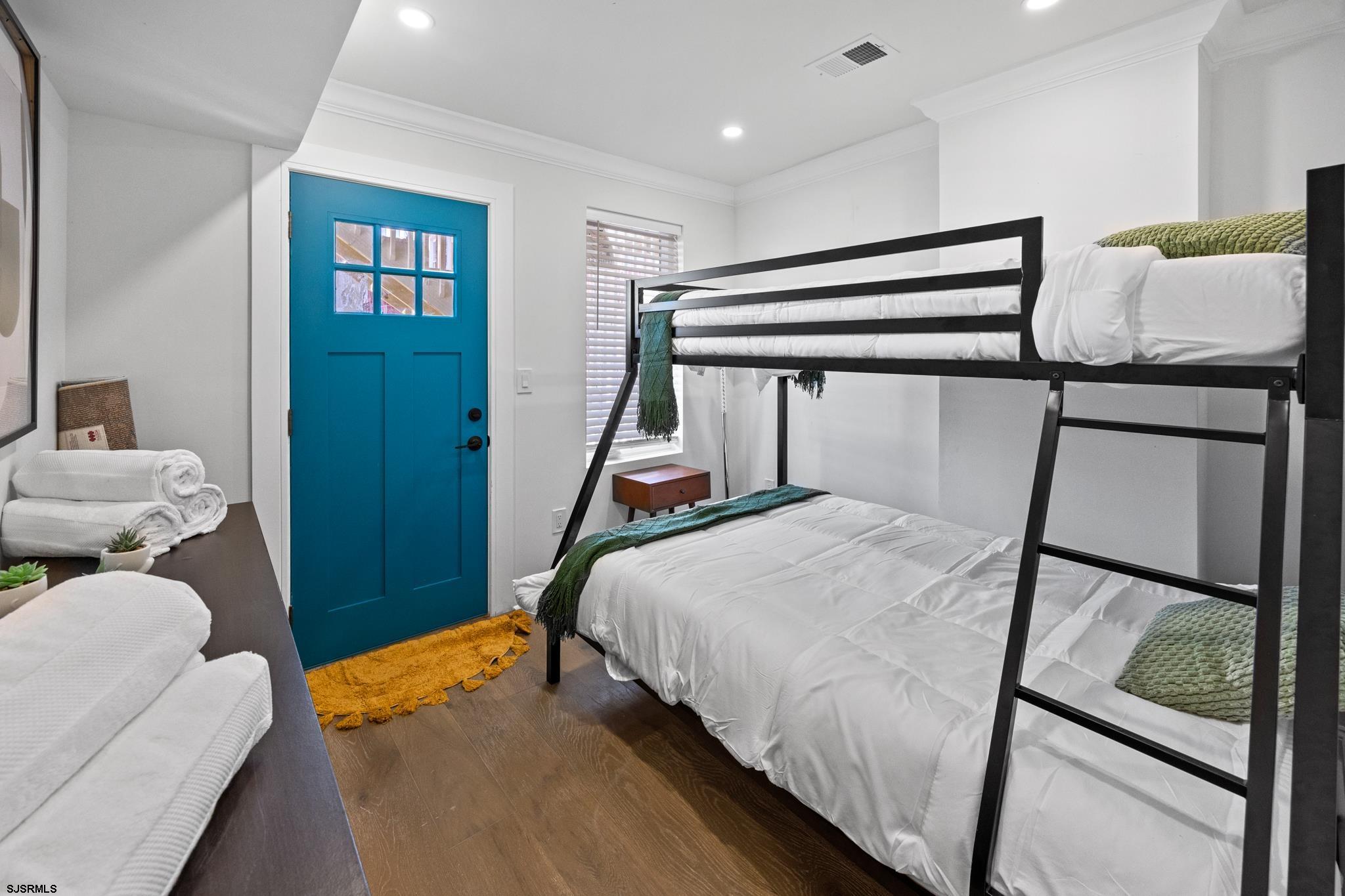 129 Seaside Avenue Atlantic City, NJ 08401 - Photo 13 of 43 a bedroom with a bed and wooden floor