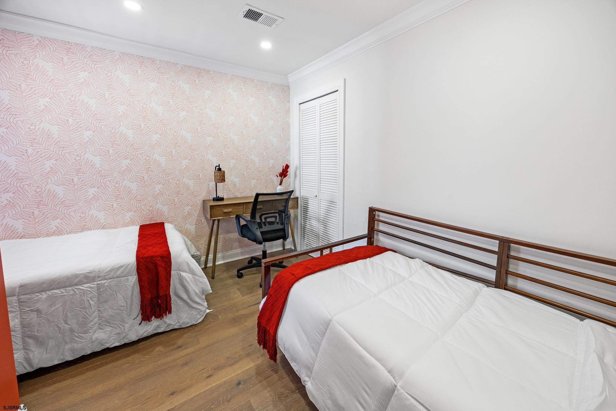 129 Seaside Avenue Atlantic City, NJ 08401 - Photo 16 of 43 a bedroom with a bed and a dresser